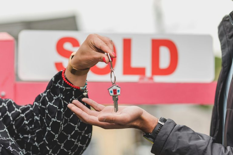 Handing over house keys, SOLD sign